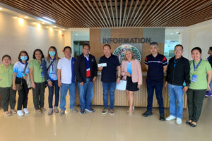 Camiguin Rep. Jurdin Jesus Romualdo (7th from left) receives the check worth P16 million from DOLE-10 as salaries of the province’s 3,990 disadvantaged beneficiaries. (Supplied photo)