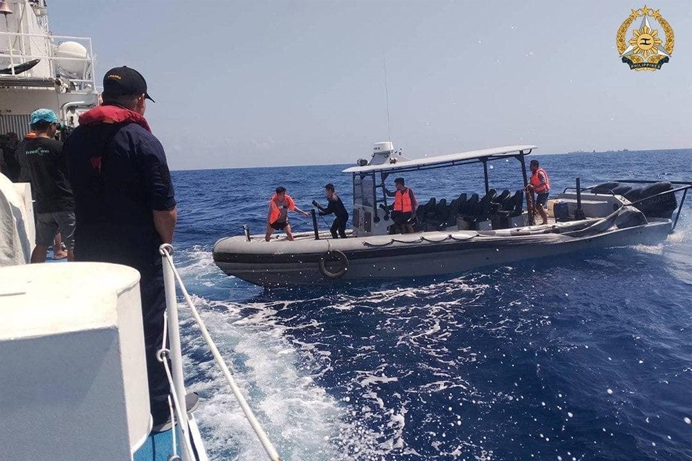 RESUPPLY MISSION. Philippine Navy soldiers transfer essential cargoes from Unaizah May 4 and BRP Cabra to the BRP Sierra Madre off Ayungin Shoal on Saturday (March 23, 2024). The resupply boat Unaizah May 4 was damaged by yet another water cannon attack by the Chinese Coast Guard. (Photo courtesy of the Armed Forces of the Philippines)